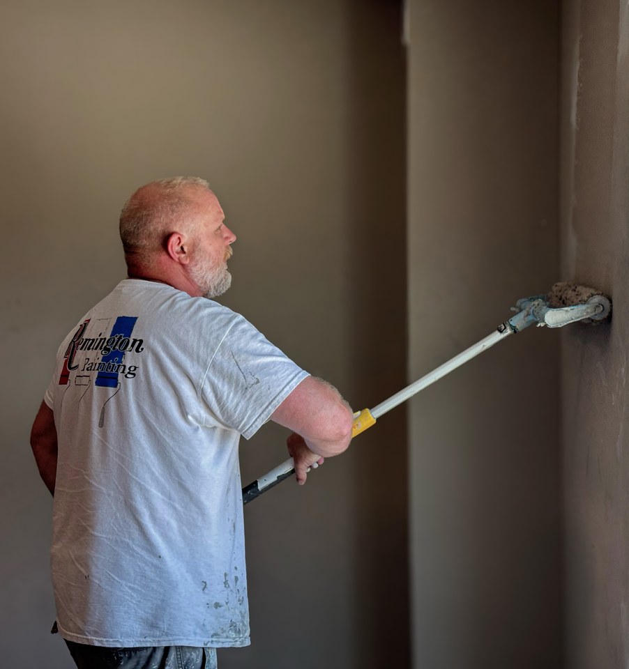 Remington Painting crew member painting an interior wall in Omaha
